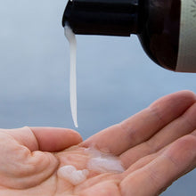 Load image into Gallery viewer, Pouring pure emu oil into hand