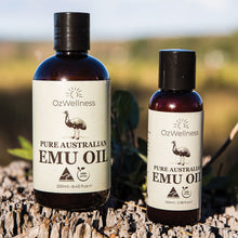 Load image into Gallery viewer, 100ml and 250ml OzWellness emu bottle on stump with farm in the background
